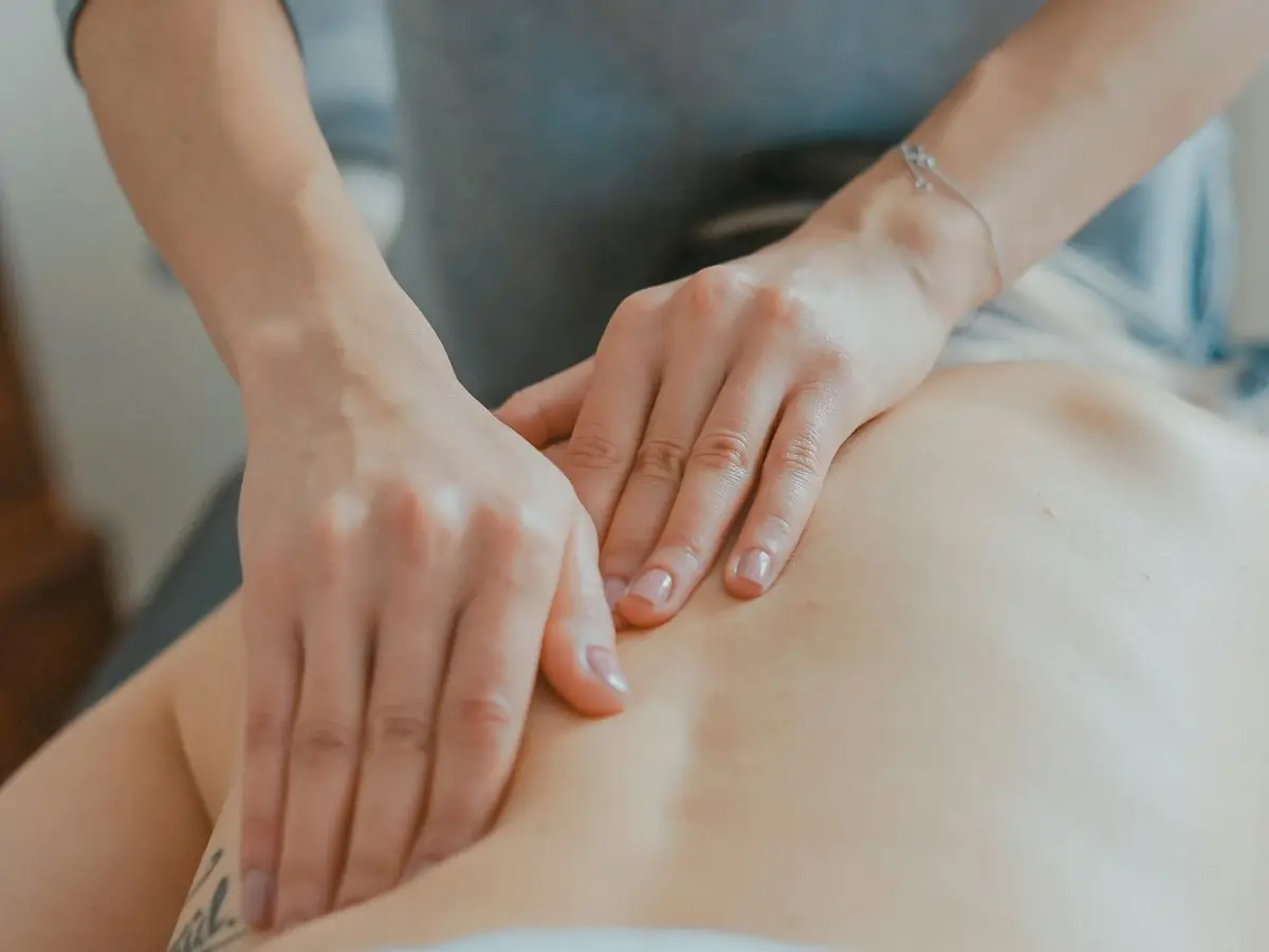 Physiotherapist treating a patient's back